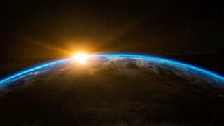 Sunrise over Earth's curved horizon with a glowing blue atmosphere and starry space backdrop. Separate the names? No—this is a general scene piece.
