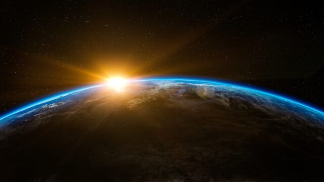 Sunrise over Earth's curved horizon with a glowing blue atmosphere and starry space backdrop. Separate the names? No—this is a general scene piece.